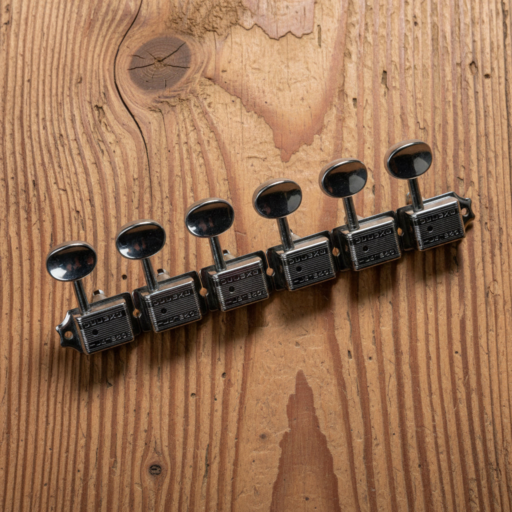 Wilkinson Deluxe vintage 6-in-line split-post guitar tuners, 15:1 ratio, close view on workbench